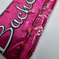 Pink bachelorette sash with white cursive text reading 'Bachelorette' with sparkles sequence - Image 2