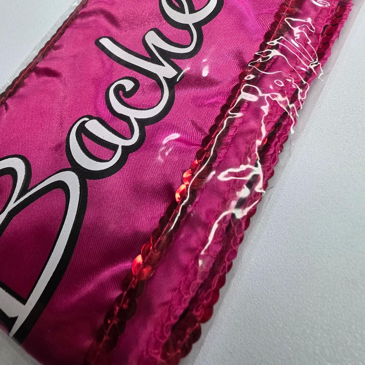 Pink bachelorette sash with white cursive text reading 'Bachelorette' with sparkles sequence - Image 2